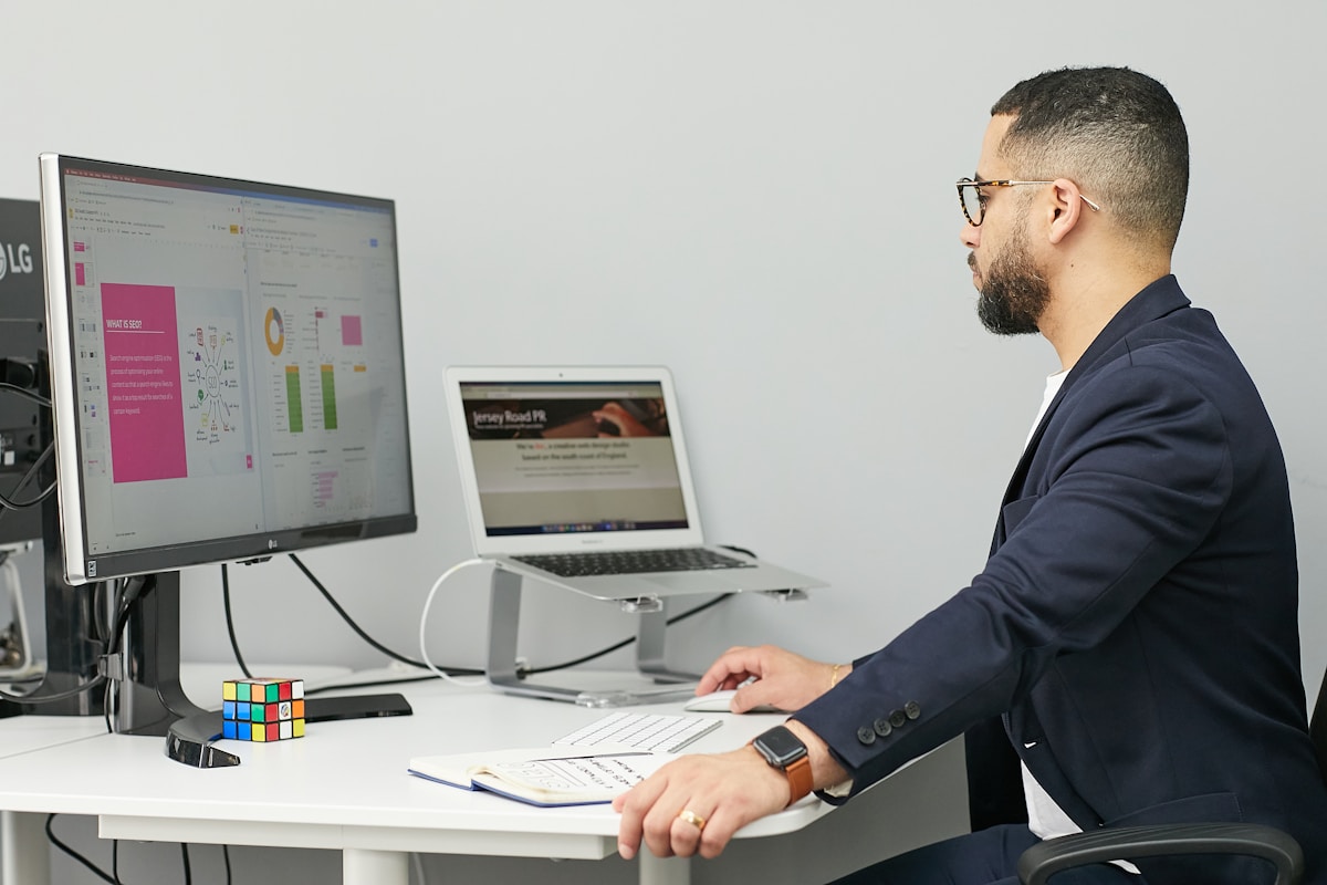 Person working with analytics on laptop and computer