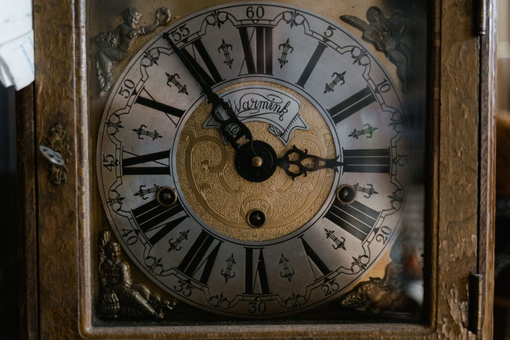 Close-up of an ornate clock face with Roman numerals.