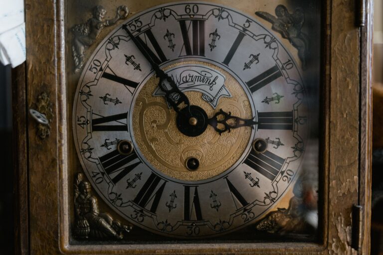 Close-up of an ornate clock face with Roman numerals.